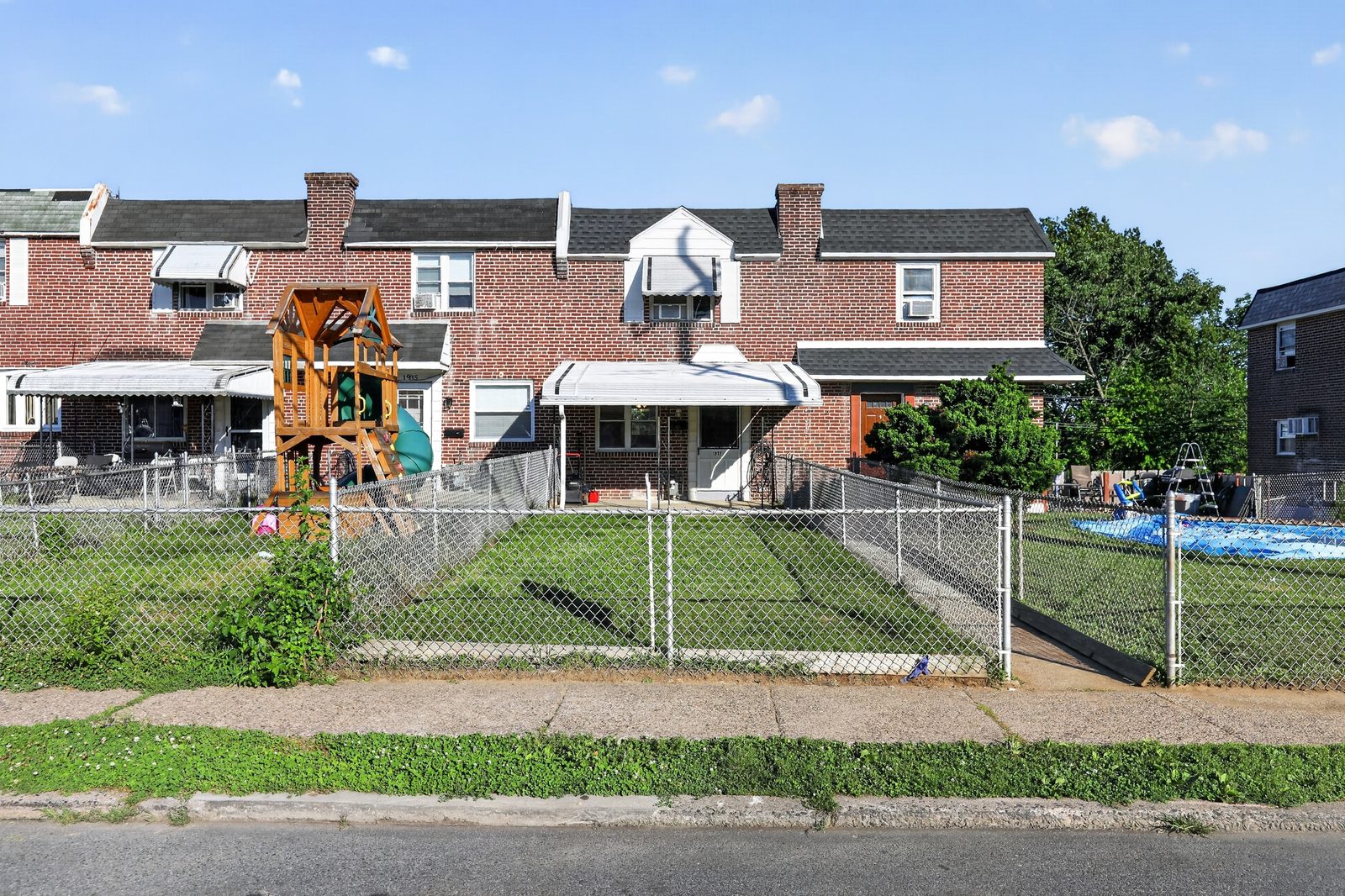 Tree-lined street of brick townhouses in Folcroft, showing the neighborhood setting