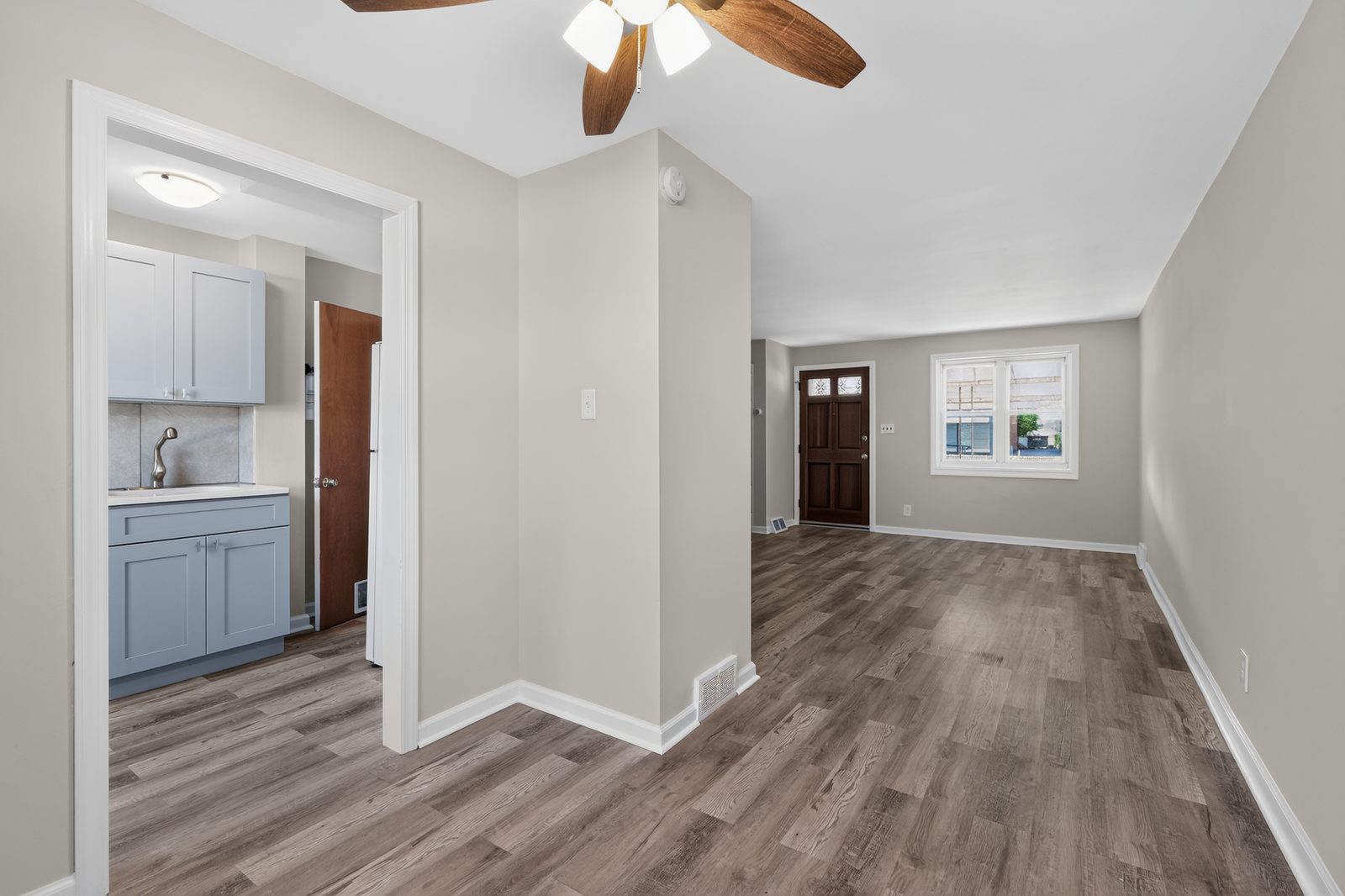 Living room of 1937 Delmar Dr — bright, freshly painted, with new flooring and natural light